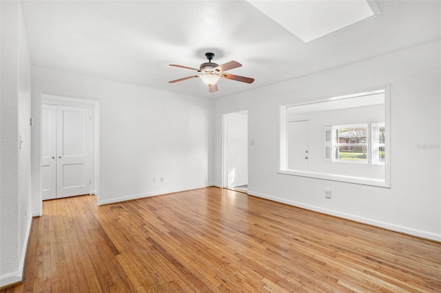 empty room with ceiling fan and light wood-type flooring