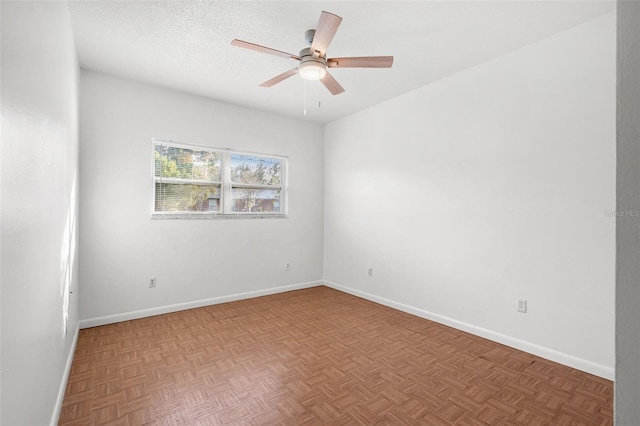 unfurnished room featuring ceiling fan, parquet flooring, and a textured ceiling