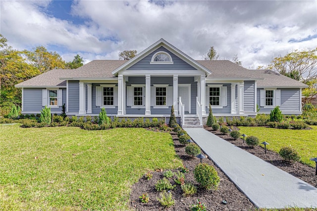 view of front of house with a porch and a front yard