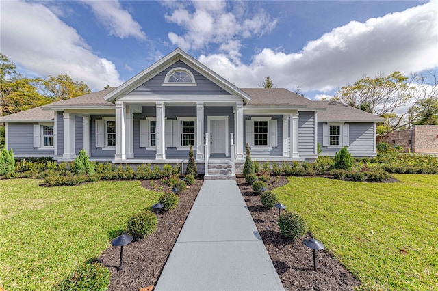 view of front of home featuring covered porch and a front yard