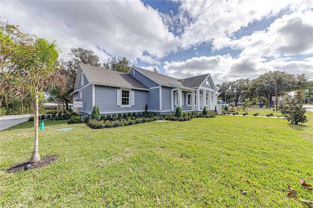 single story home featuring a front lawn