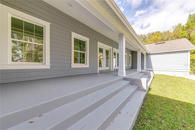 deck with a lawn and covered porch