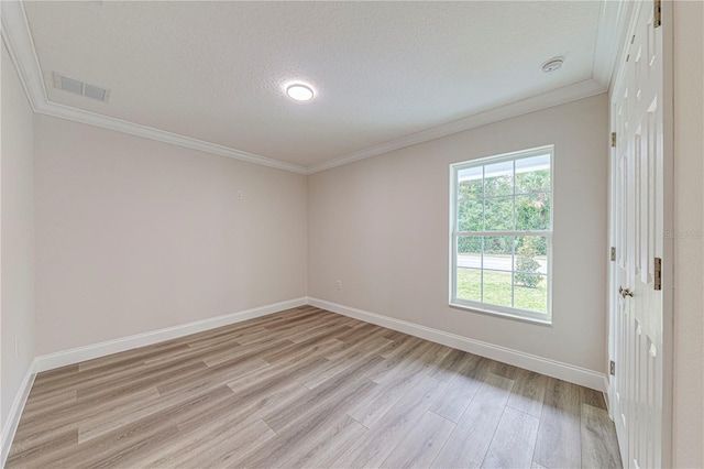 unfurnished room with a textured ceiling, light wood-type flooring, and crown molding