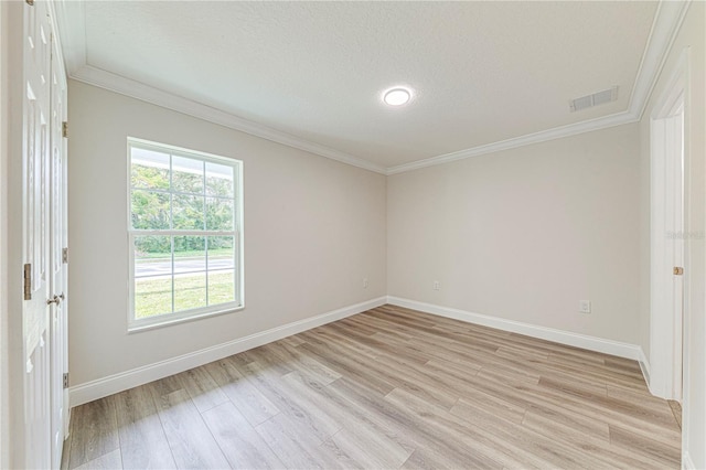 spare room with crown molding, light hardwood / wood-style floors, and a textured ceiling