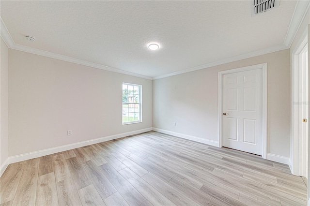 spare room with crown molding, light hardwood / wood-style floors, and a textured ceiling