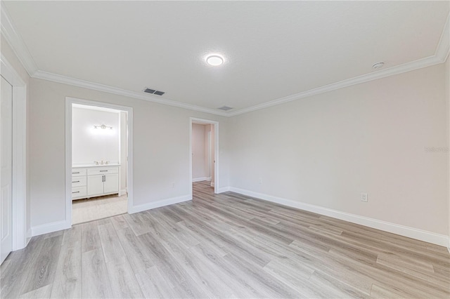 unfurnished bedroom featuring ensuite bath, crown molding, and light wood-type flooring