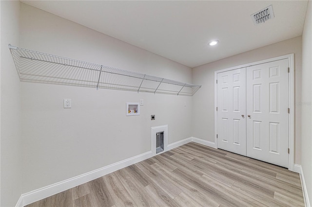 clothes washing area featuring electric dryer hookup, hookup for a washing machine, and light wood-type flooring