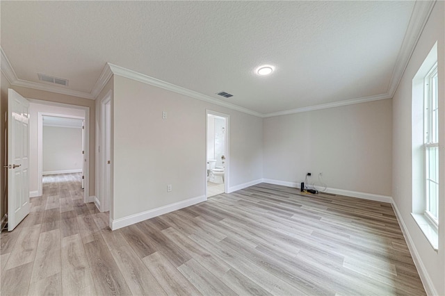 unfurnished room with light hardwood / wood-style floors, a textured ceiling, and ornamental molding