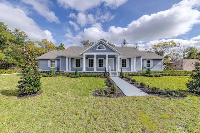 view of front facade featuring a front yard and covered porch