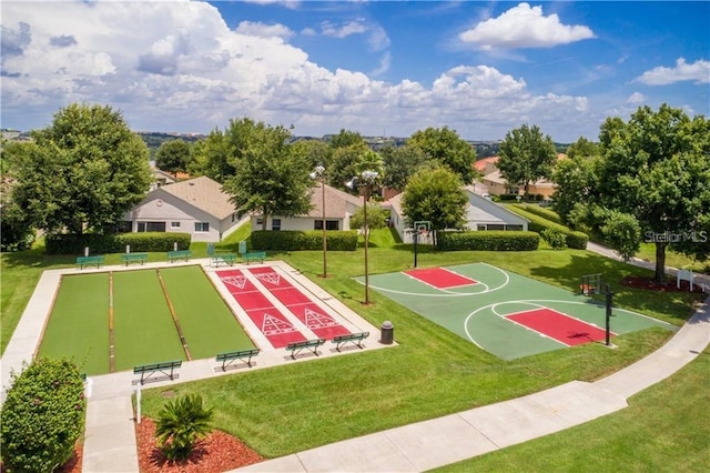 view of sport court with a lawn