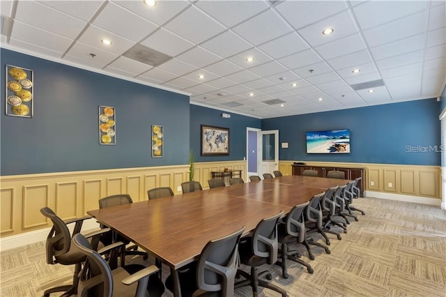 dining space featuring light carpet and a paneled ceiling