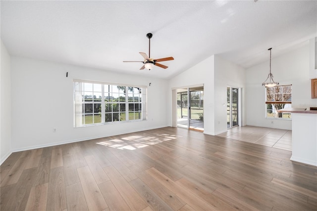 unfurnished living room featuring ceiling fan, light hardwood / wood-style floors, and lofted ceiling