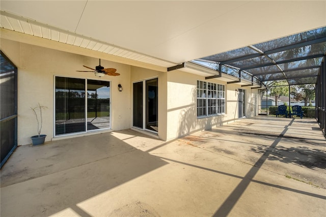 view of patio featuring glass enclosure and ceiling fan