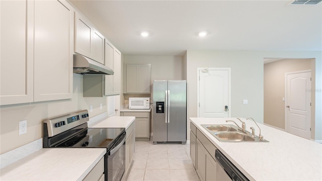 kitchen featuring appliances with stainless steel finishes, light tile patterned floors, and sink