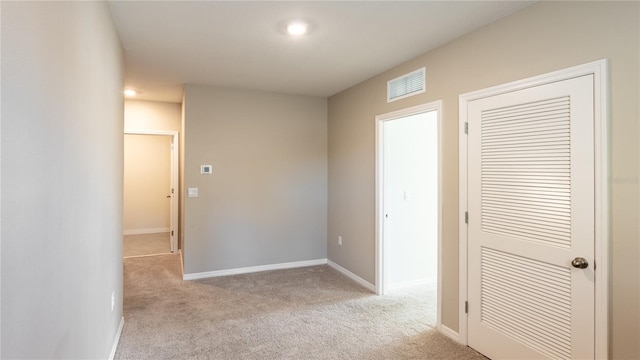 corridor with light carpet