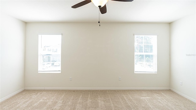 carpeted empty room featuring ceiling fan