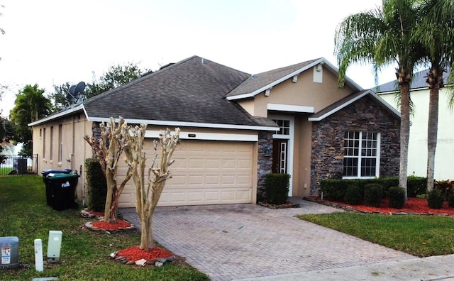 view of front of home featuring a front yard and a garage