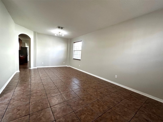 empty room featuring dark tile patterned flooring