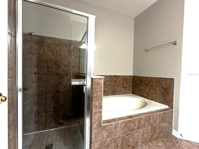 bathroom with separate shower and tub and tile patterned floors