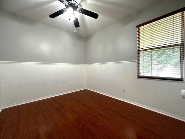 empty room with hardwood / wood-style floors, ceiling fan, and a healthy amount of sunlight