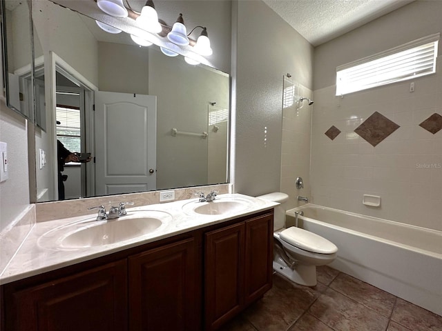 full bathroom with toilet, a textured ceiling, a wealth of natural light, and tiled shower / bath