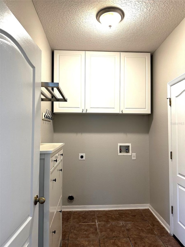 laundry room with cabinets, washer hookup, a textured ceiling, and electric dryer hookup