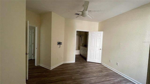 unfurnished bedroom featuring ceiling fan and dark wood-type flooring