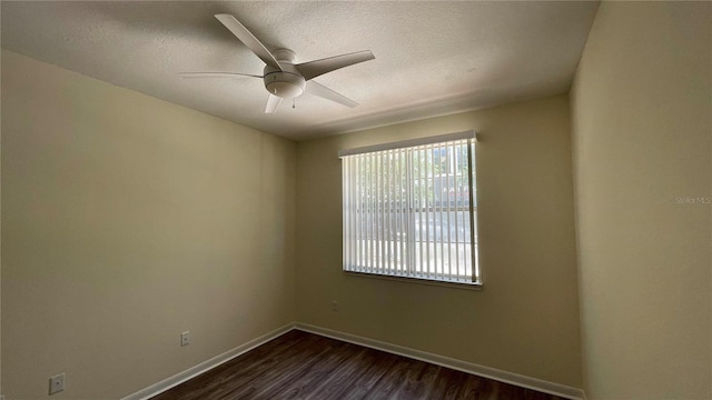 unfurnished room with ceiling fan and dark hardwood / wood-style floors