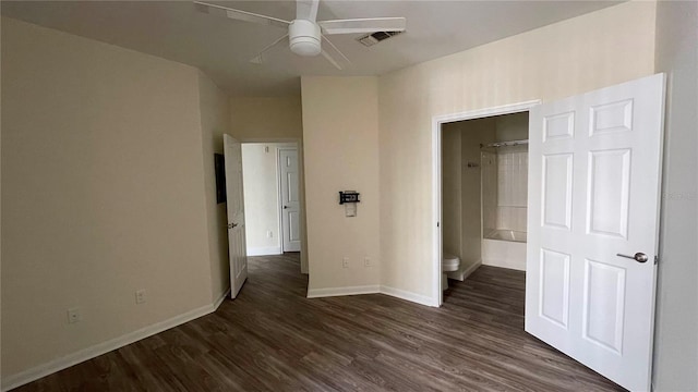 unfurnished bedroom with ensuite bathroom, ceiling fan, and dark hardwood / wood-style floors