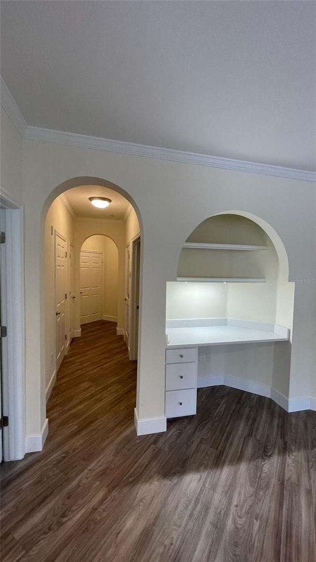 corridor featuring dark hardwood / wood-style floors and crown molding