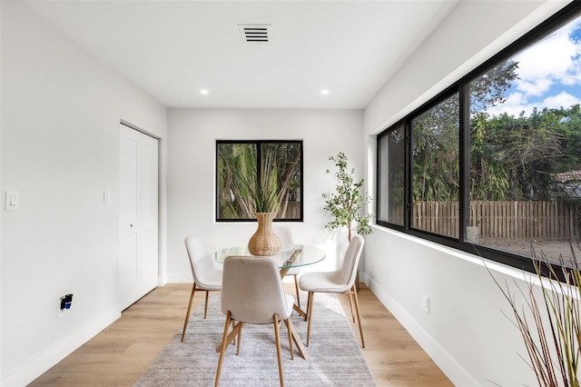 dining room featuring a healthy amount of sunlight and light hardwood / wood-style floors