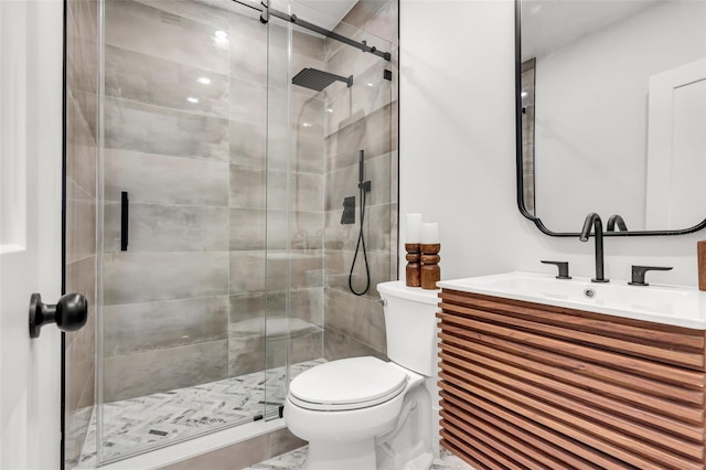 bathroom with a shower with door, vanity, and toilet