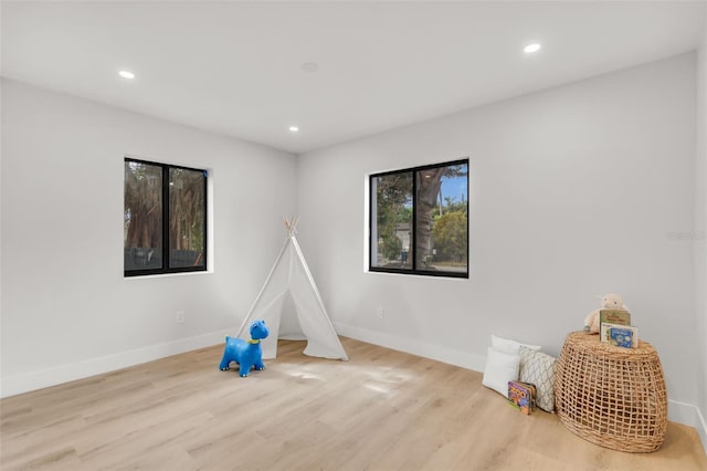 game room with light wood-type flooring