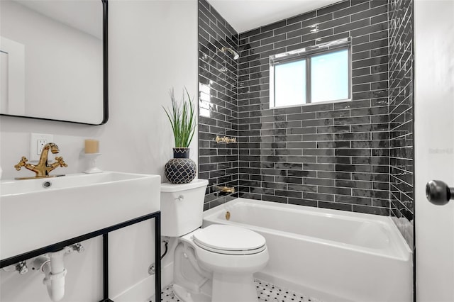 full bathroom featuring vanity, tiled shower / bath combo, and toilet