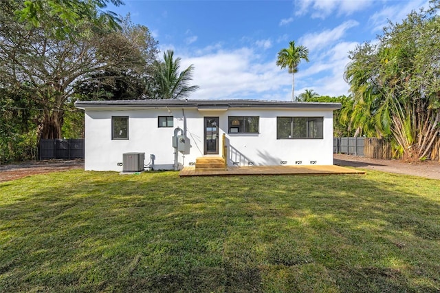 ranch-style house with a front yard and central air condition unit