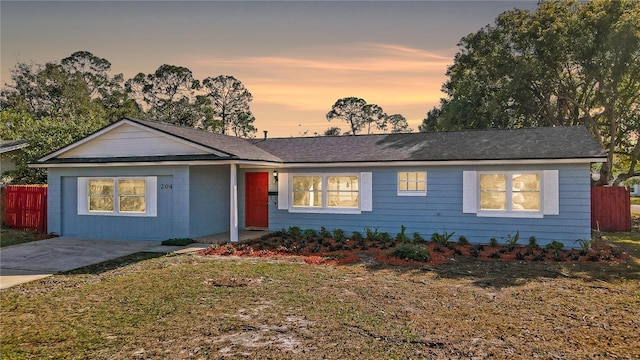 ranch-style home with a lawn