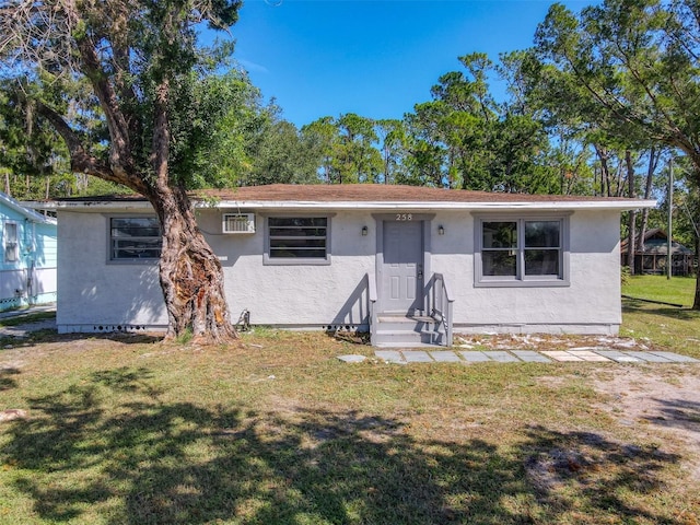 ranch-style home with a front lawn