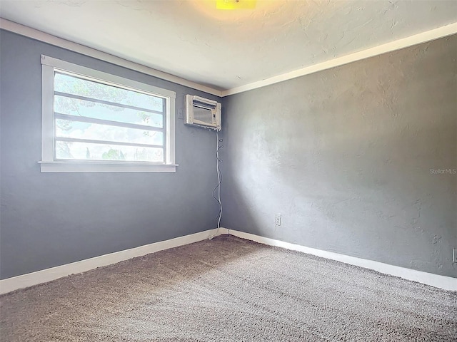 empty room with carpet floors and a wall unit AC