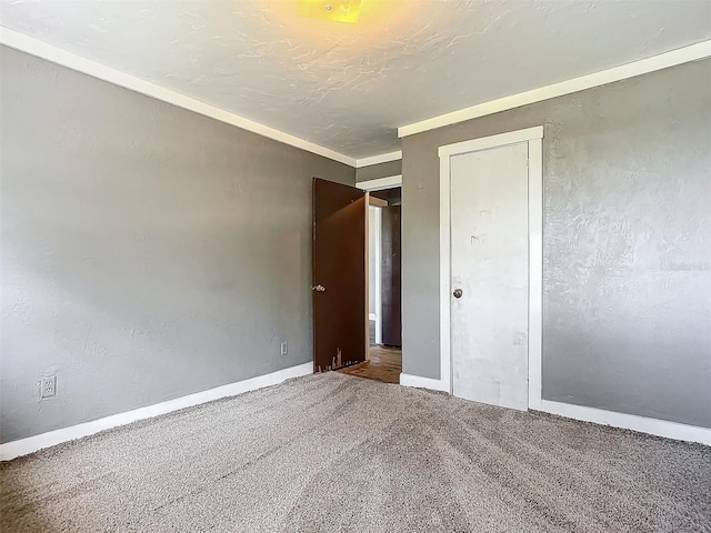 unfurnished bedroom featuring carpet floors, a textured ceiling, and a closet