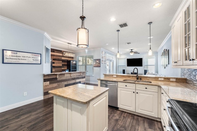 kitchen featuring sink, ceiling fan, a kitchen island, light stone counters, and stainless steel appliances