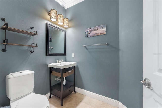 bathroom featuring toilet, tile patterned flooring, and ornamental molding