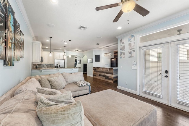 living room featuring french doors, dark hardwood / wood-style flooring, ceiling fan, and crown molding