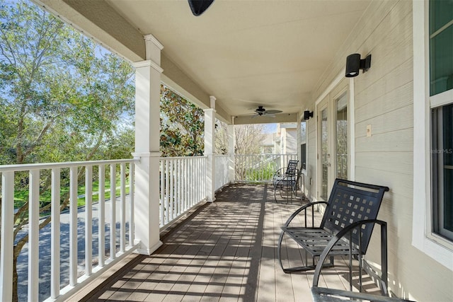 wooden terrace featuring ceiling fan and covered porch