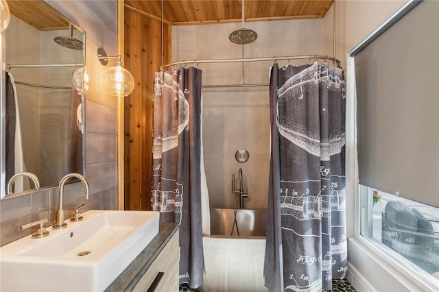 bathroom featuring shower / bath combo with shower curtain, sink, and wood ceiling