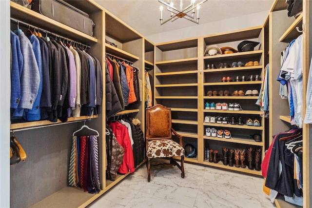 walk in closet with a notable chandelier