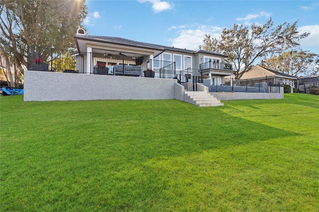 rear view of house featuring a yard