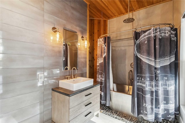 bathroom with tile walls, vanity, wood walls, wooden ceiling, and tile patterned floors