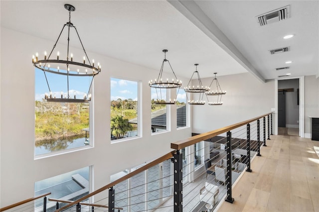 hall featuring light wood-type flooring and a water view