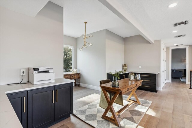 interior space with light wood-type flooring and pendant lighting