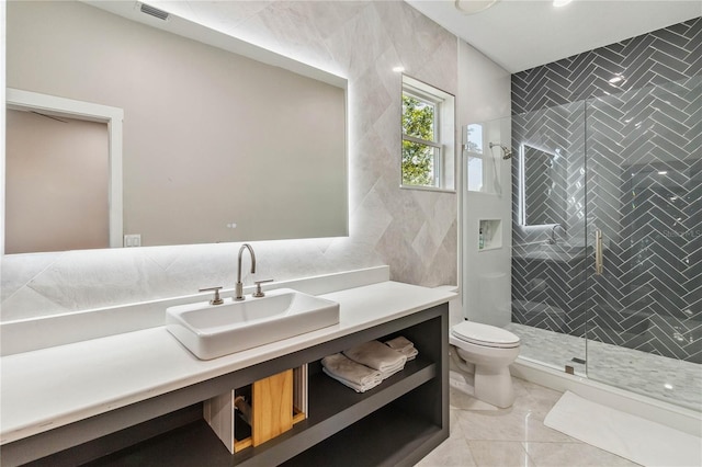 bathroom with vanity, tile walls, toilet, and an enclosed shower